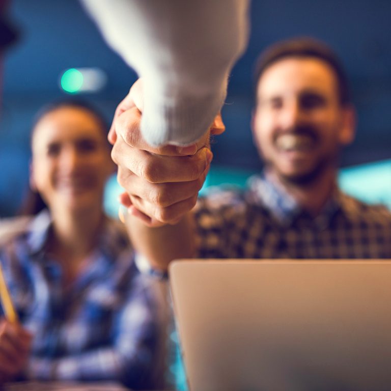 A handshake at the end of a successful sales meeting