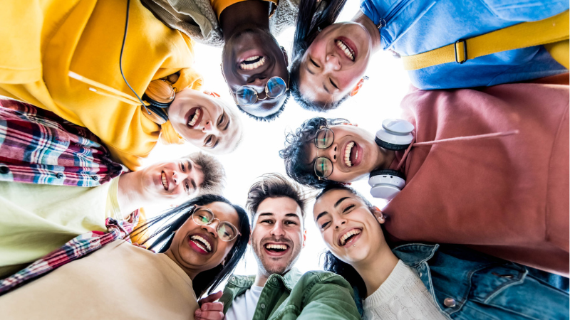 group of people in a huddle looking down