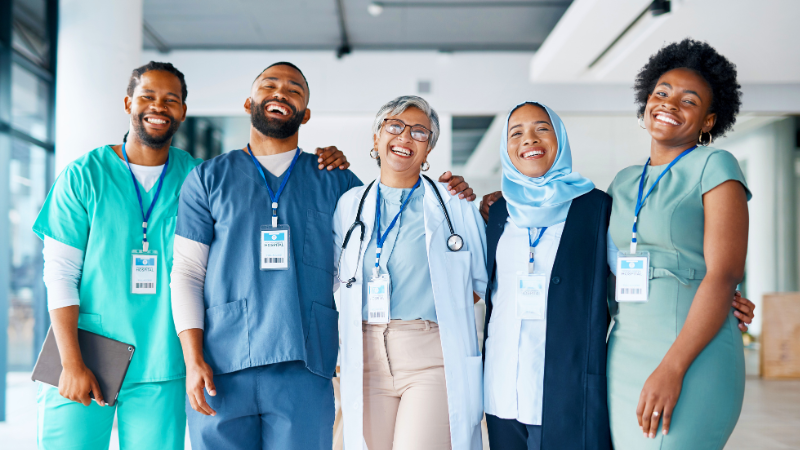 healthcare team smiling while hugging