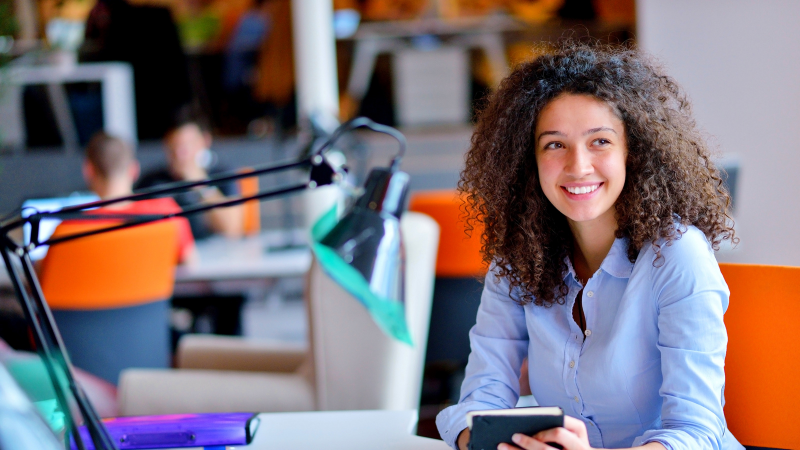 woman sitting alone at a desk with her planner