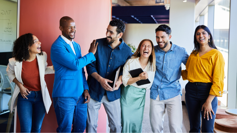 team members laughing and enjoying their work day together.