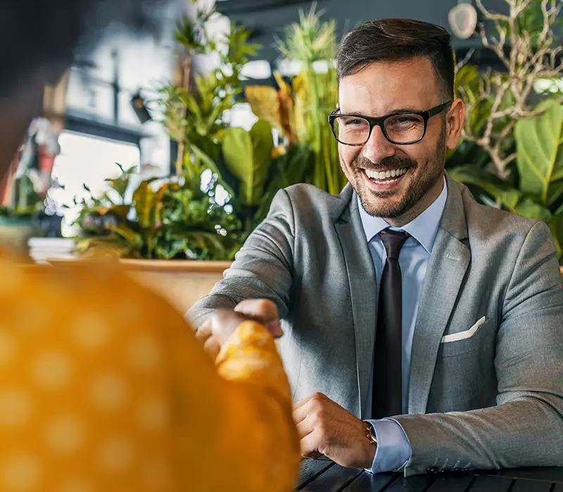 Man at a job interview shaking hands with the interviewer.