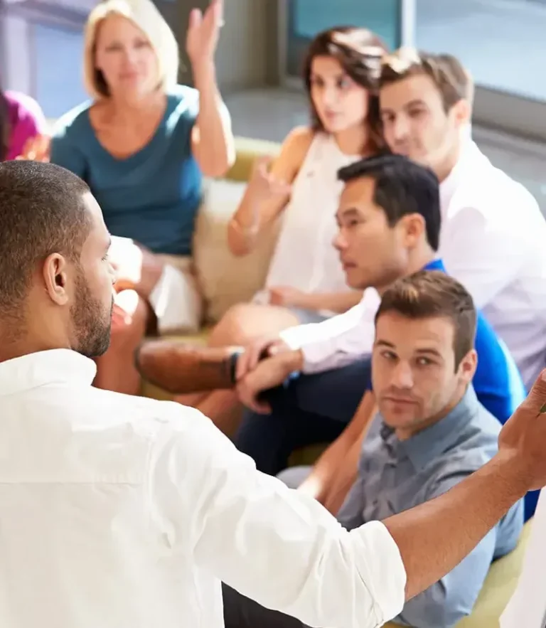 A man giving a presentation to his team members