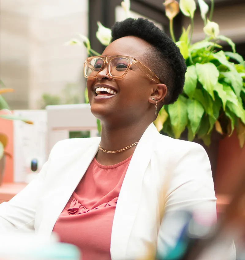A professional woman laughing during a meeting
