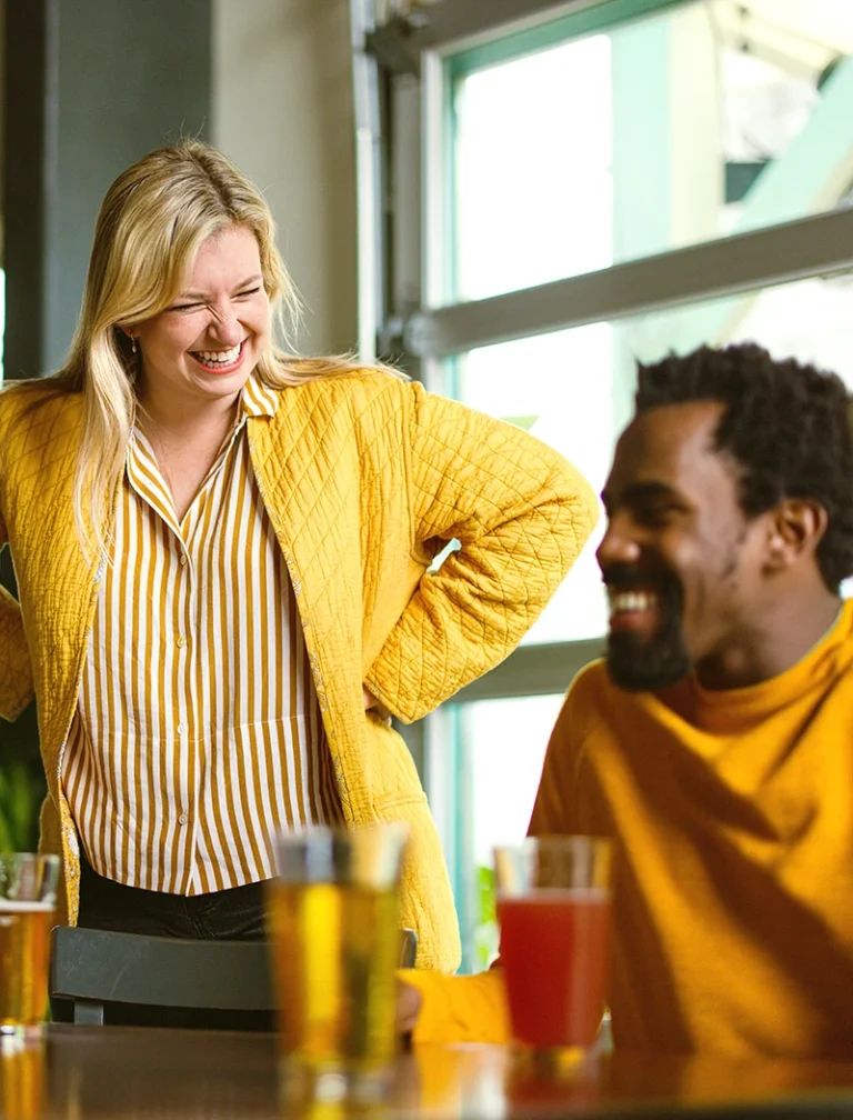 A woman and man laughing at work