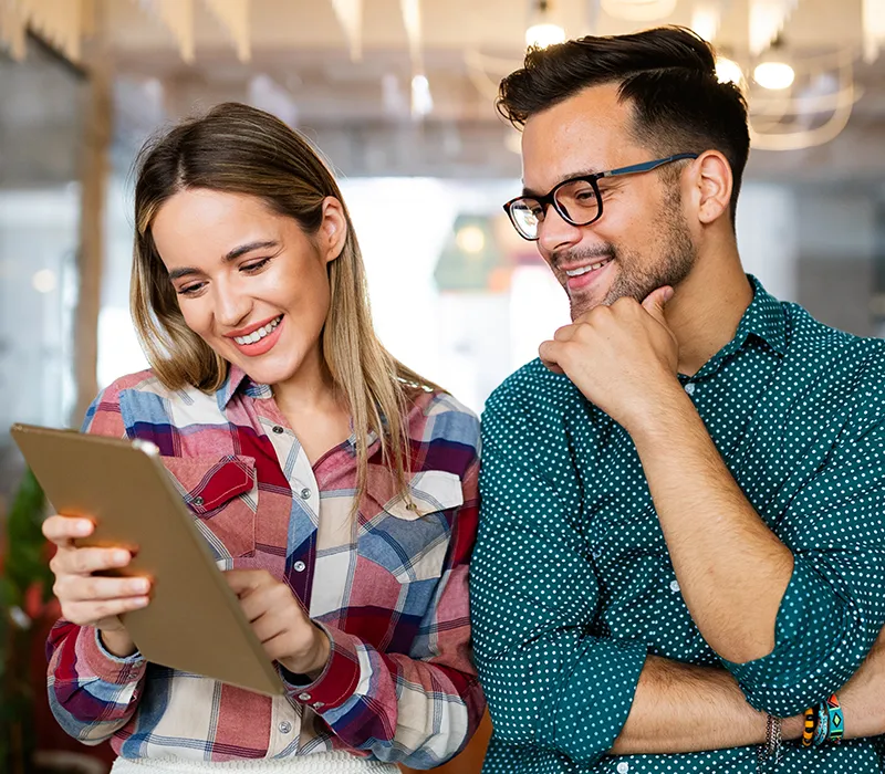 A woman and a man going over their MCode Assessment results realizing they are both Achievers.
