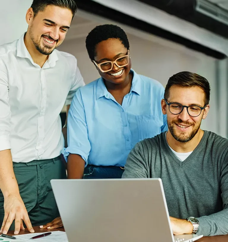 A group of employees reviewing their organization's MCode results while smiling.