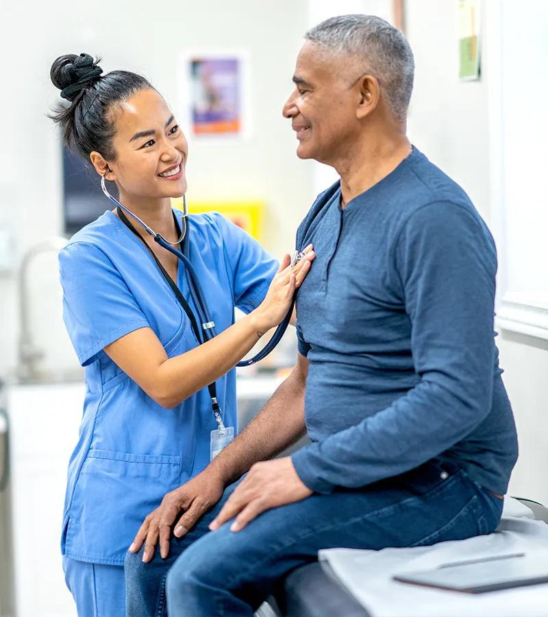 A Nurse checking a patients heartbeat
