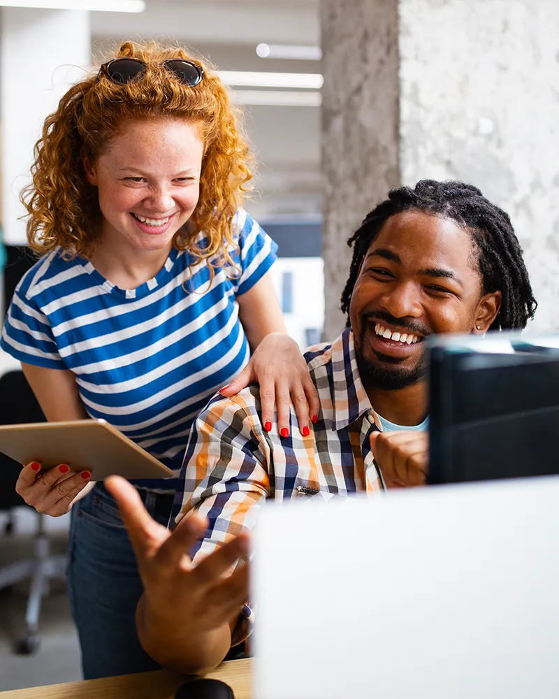 Co-workers working and laughing together